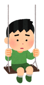 ブランコに乗って悲しそうな顔をしている男の子のイラスト